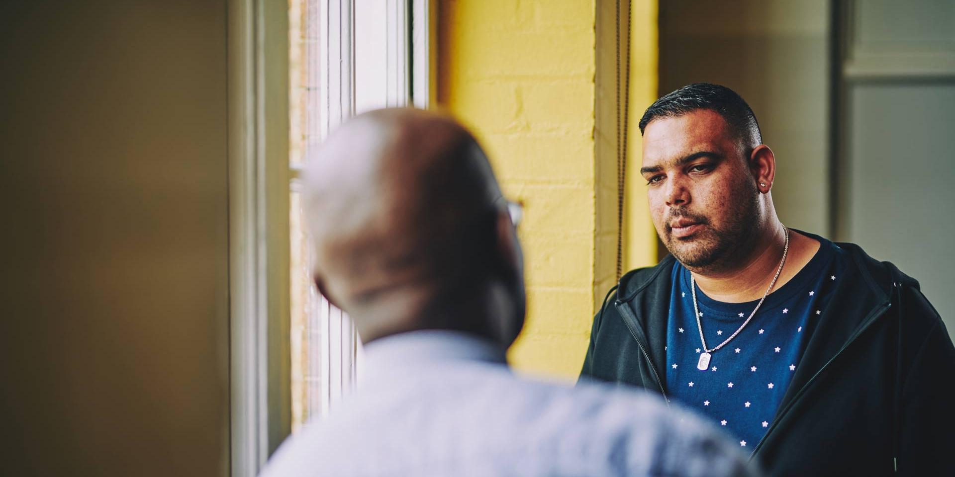 two men talking in a corridor