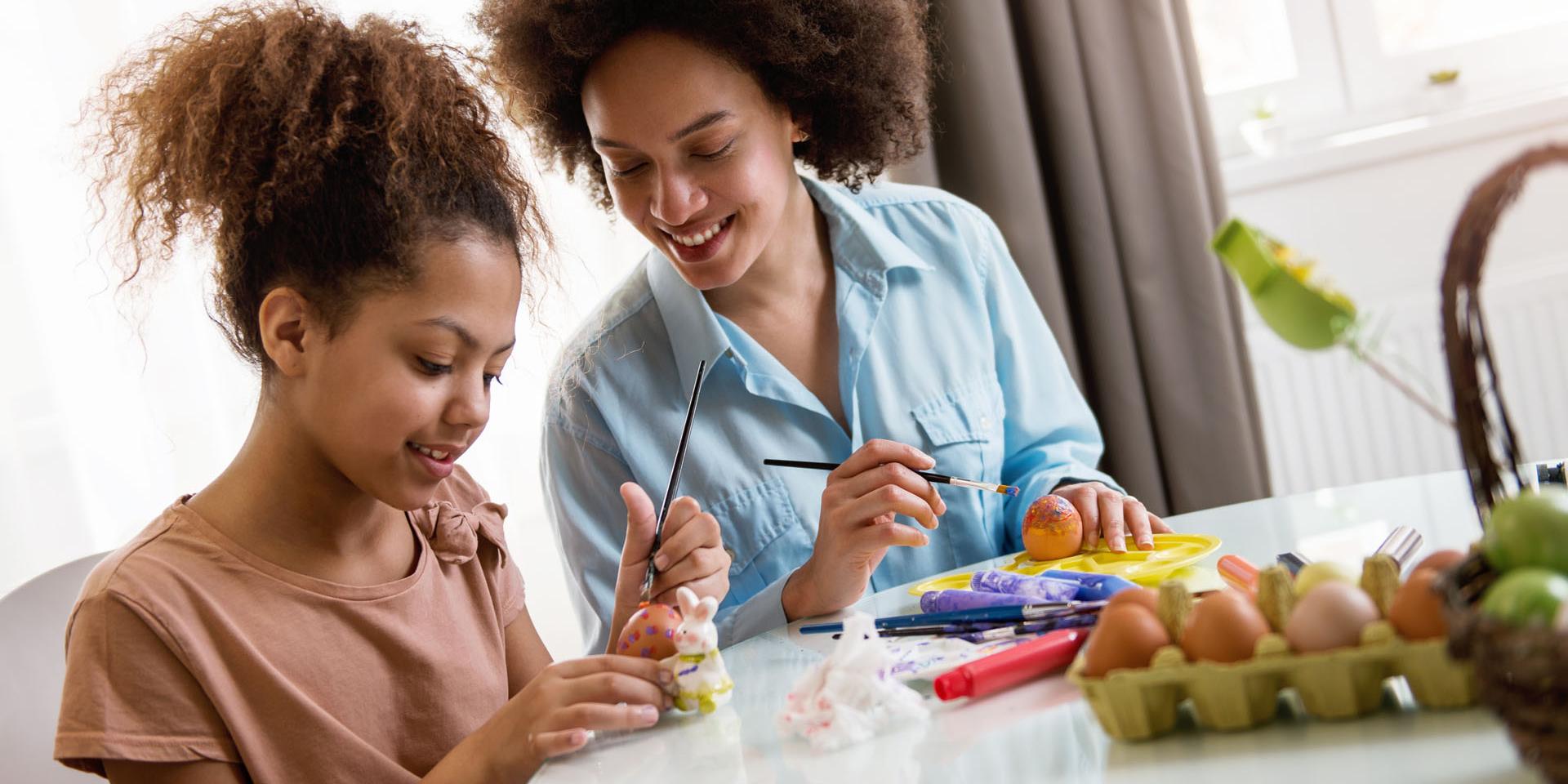 A woman and a child doing a craft activity